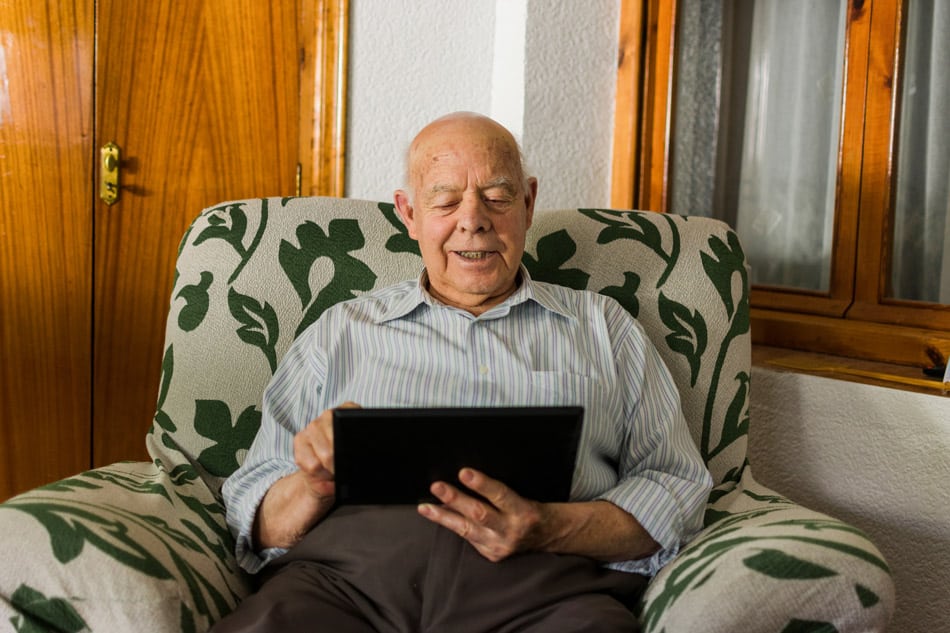 elderly-man-is-using-a-digital-tablet-at-home